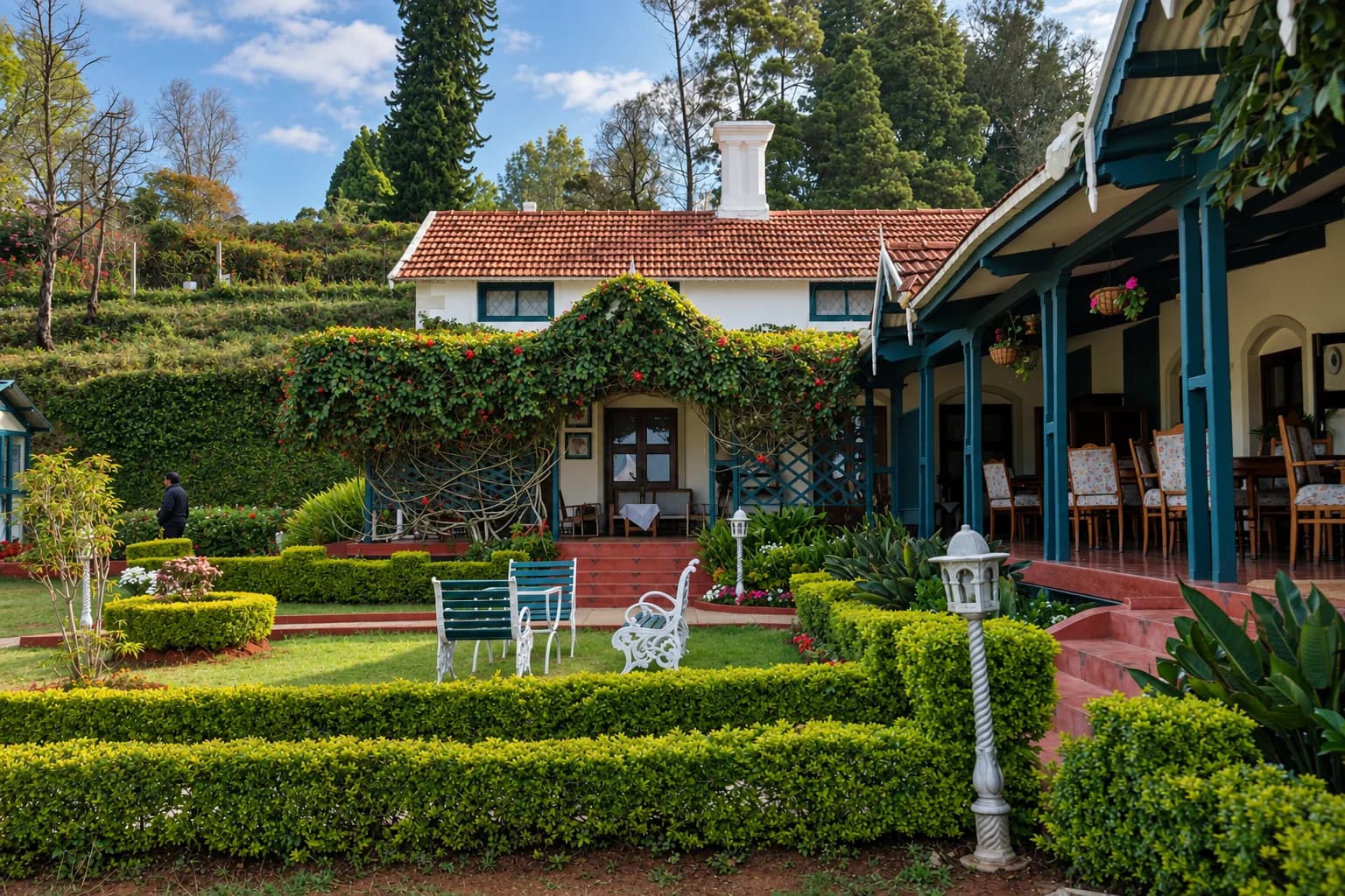 The house on its terraced garden, hedges below the veranda
