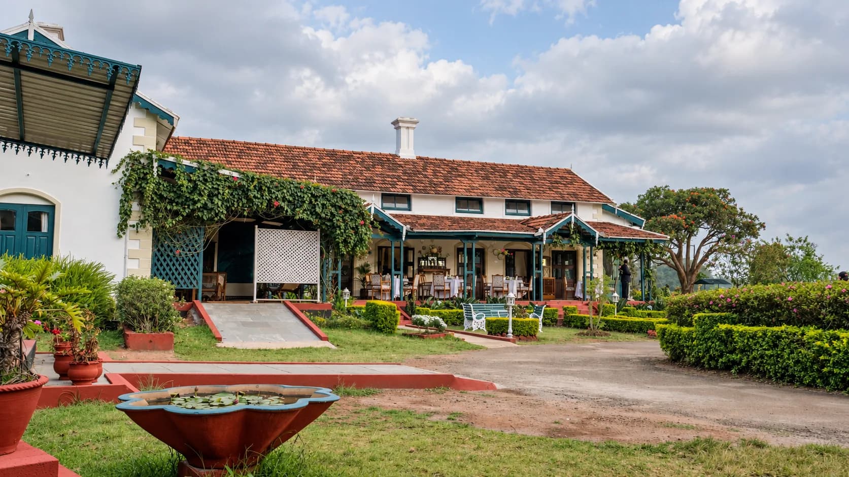 The house across the forecourt, a stone planter in front