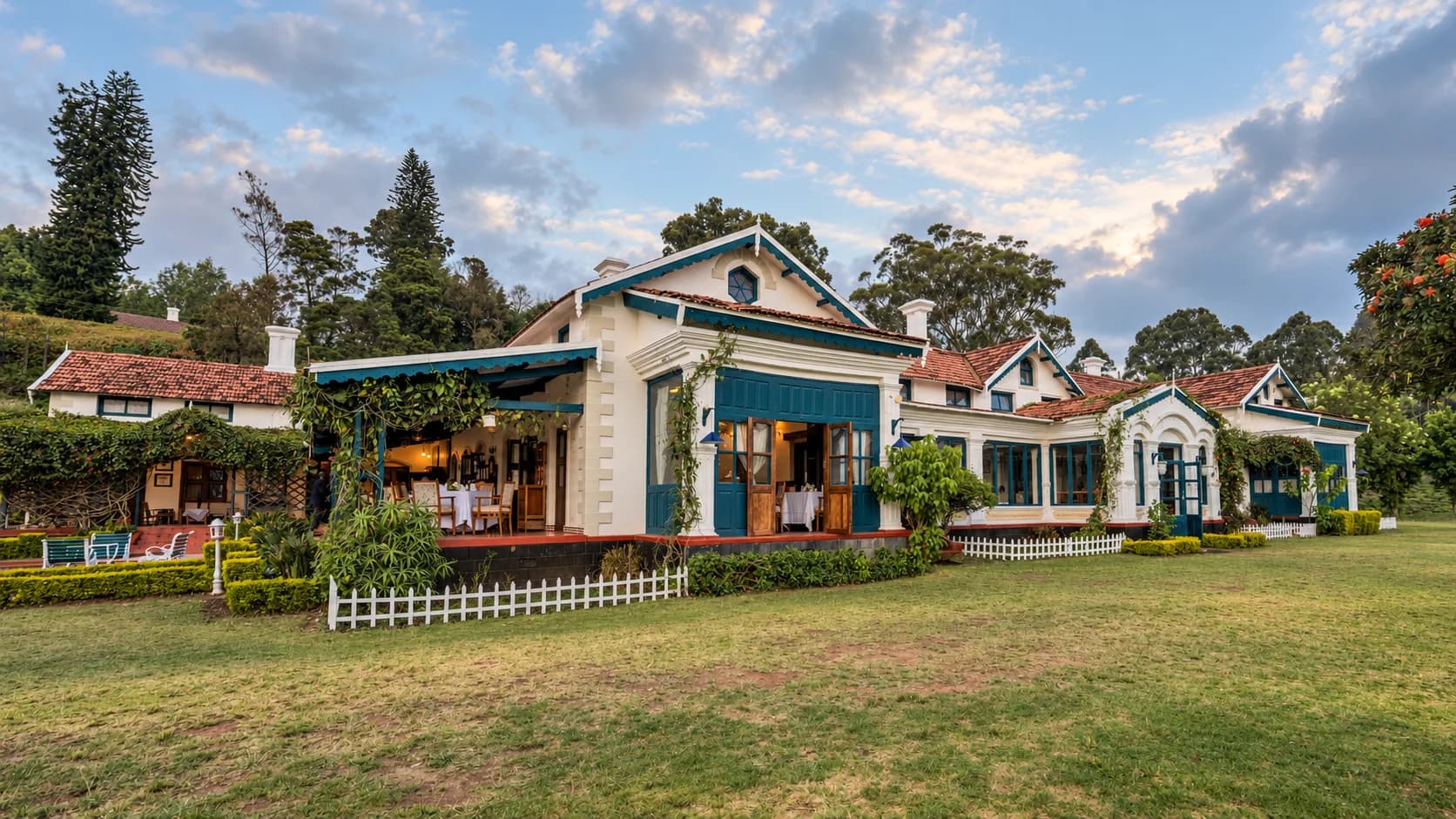 The house across the lawn behind a white picket fence