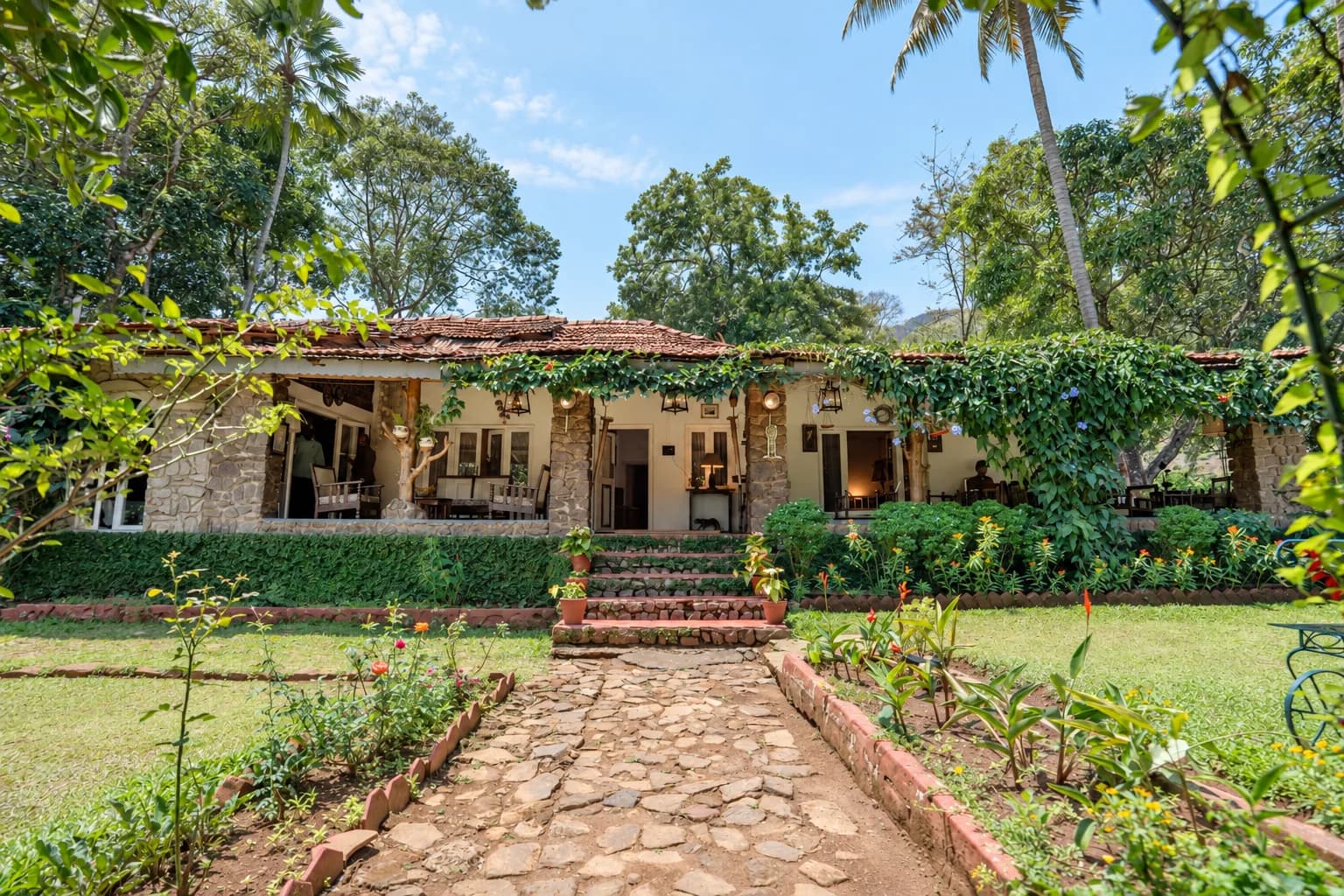 The long stone bungalow down the garden path, under palms
