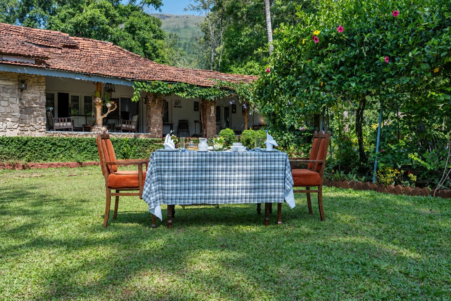 A table laid on the lawn in front of the house