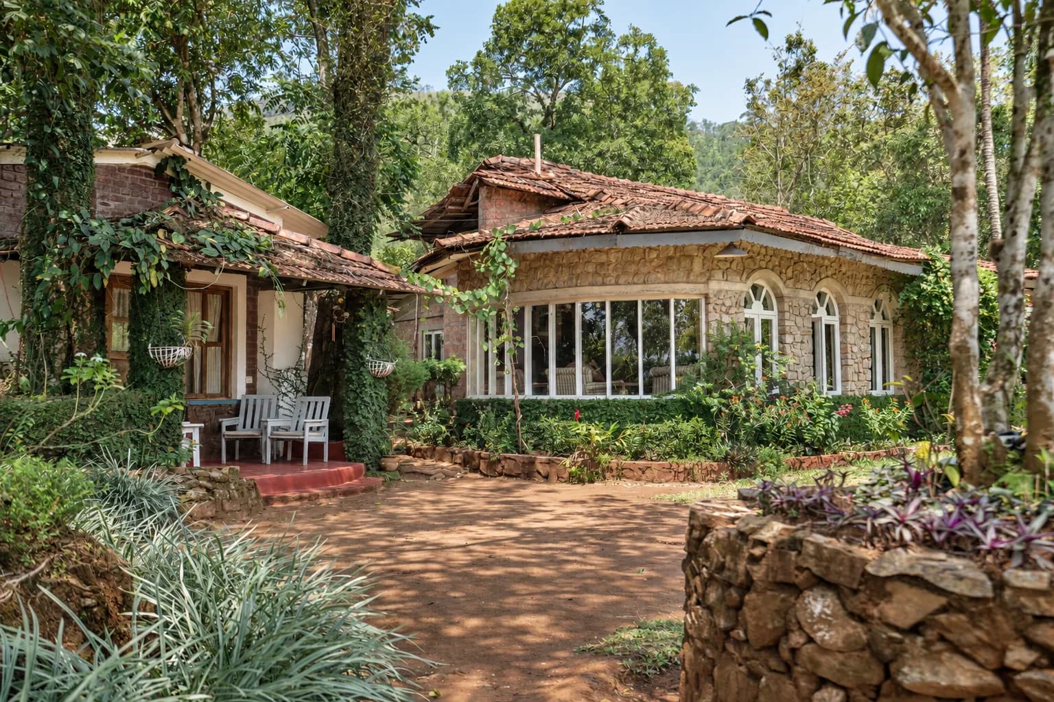 The house among the trees, seen over a stone retaining wall