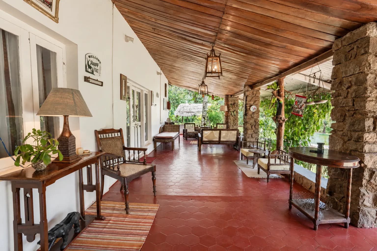 The veranda running the length of the house, lanterns overhead