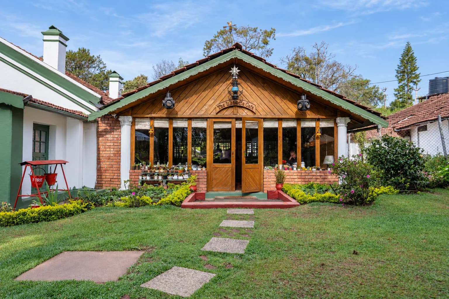 The Magnolia Cafe veranda across the lawn, stepping stones leading to the door